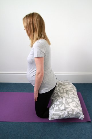 Preparation for the child's pose stretch.