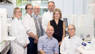A group of healthcare professionals standing in a laboratory