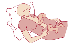 mother lying down with baby on top breastfeeding