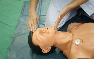 CPR for child - put one hand on forehead, tilt head back and lift chin