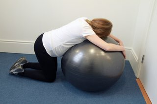 woman lying forward on a birthing ball