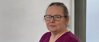 Headshot of female healthcare worker wearing glasses and hair tied back
