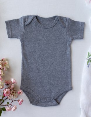 A baby's bodysuit with envelope folds at the shoulders