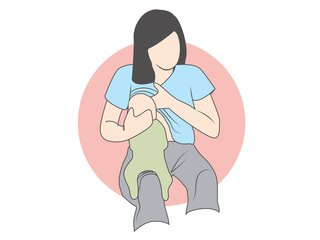 Mother straddling baby on thigh, holding upright to feed