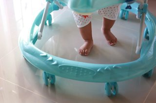 A baby standing up in a baby walker