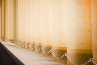 Vertical blinds with a link chain running along the bottom of the blinds