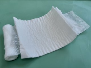 A bandage attached to a sterile dressing pad.