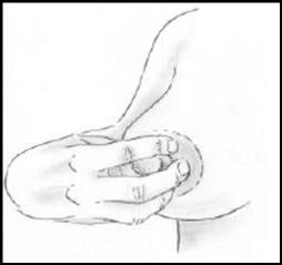 A woman holding the base of her nipple with her fingertips