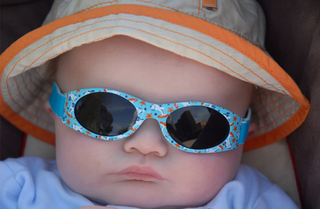 Baby wearing wraparound sunglasses